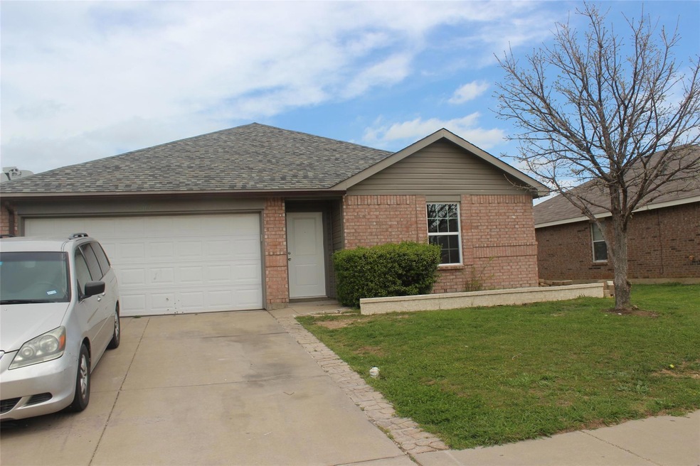 Ranch-style house featuring a front yard and a garage
