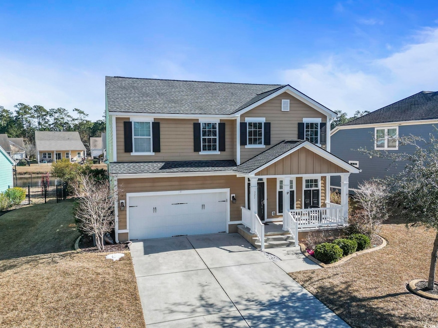 View of front property featuring a garage and cove