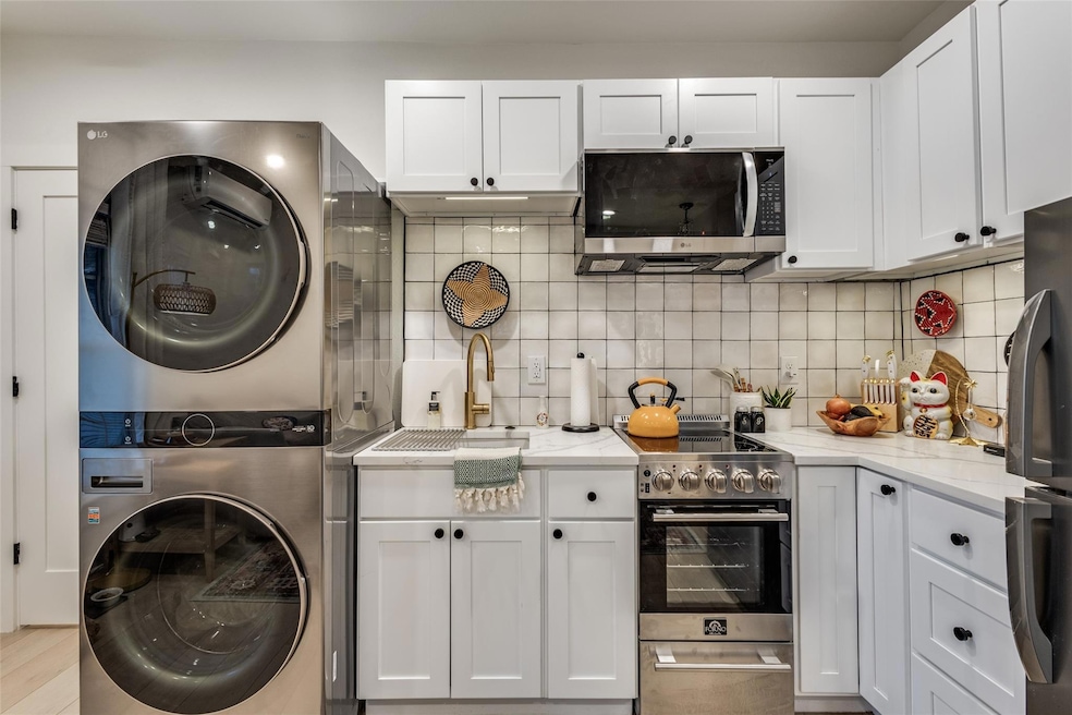 Kitchen with stainless steel appliances, stacked w