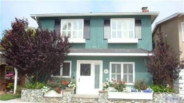 Exterior of home, quaint front patio area with pla