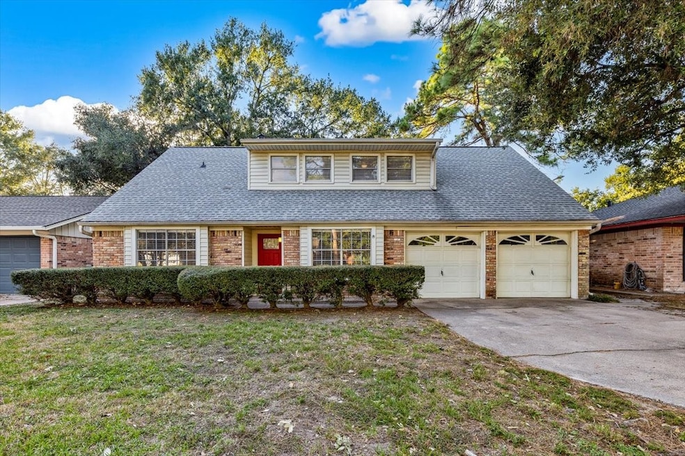 Street view of the home with a spacious front yard.