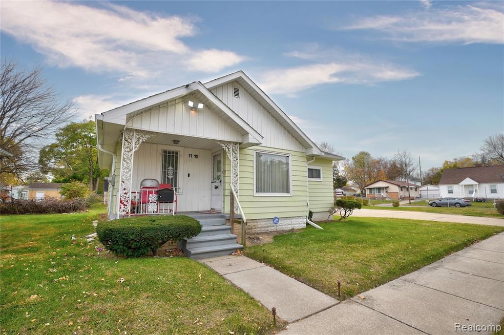 Bungalow-style house featuring a front yard, a porch, and board and batten siding