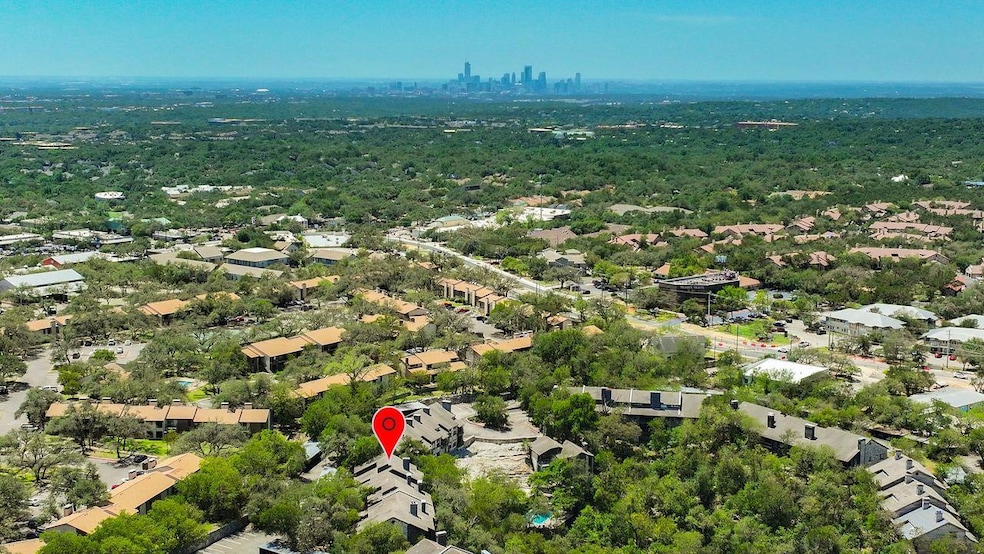 Aerial view of property and surrounding area featuring city skyline