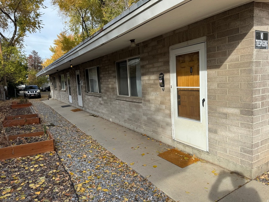 View of side of property featuring a garden and brick siding
