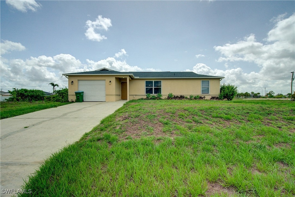 Ranch-style home featuring a garage, stucco siding