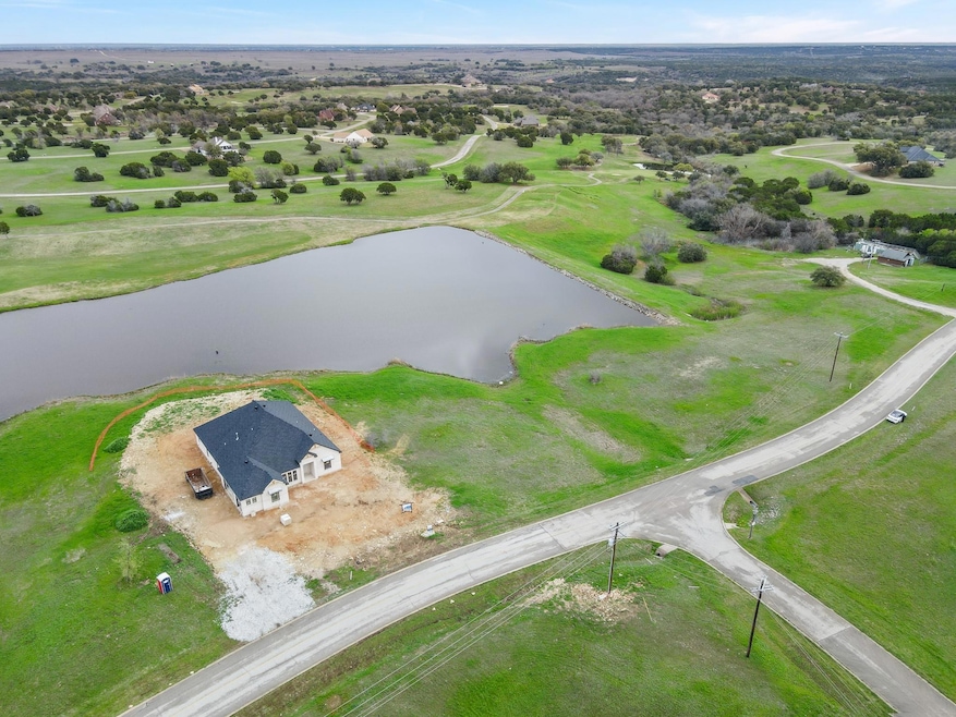 Drone / aerial view with a water view and a rural 