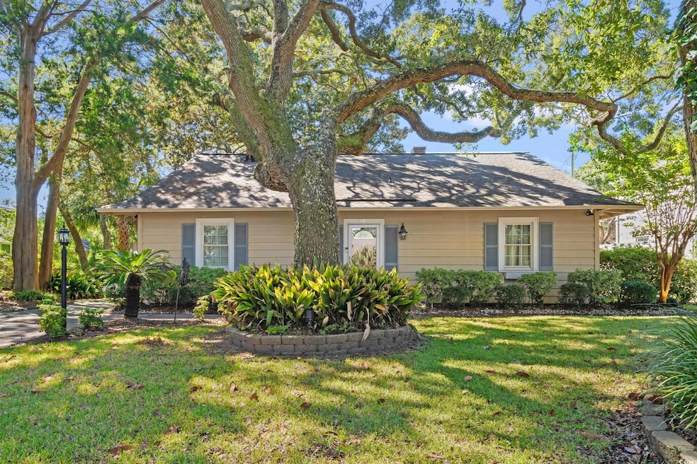 View of front of property featuring a front lawn and roof with shingles