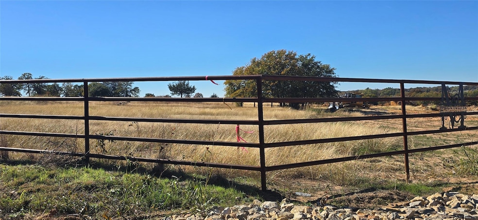 Corner lot with pipe fence all on one side