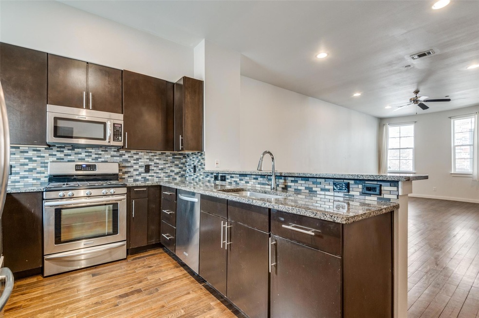 2nd floor. Kitchen with visible vents, a peninsula