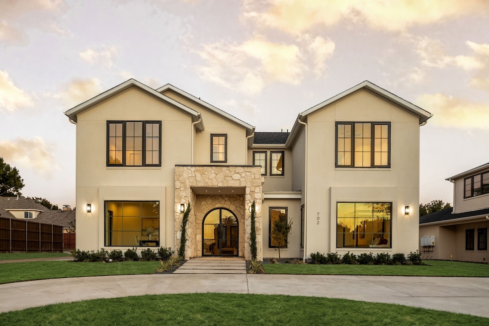 View of front of home featuring stone siding and stucco siding