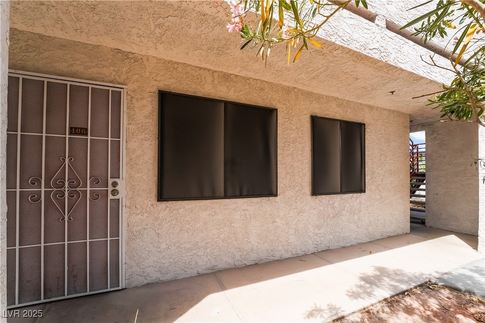 View of side of property with stairway and stucco