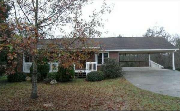 Exterior Front. Country setting 3 sided brick ranc
