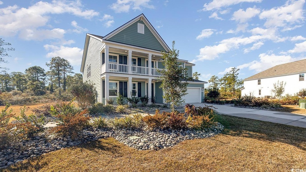 View of front facade featuring a balcony, driveway