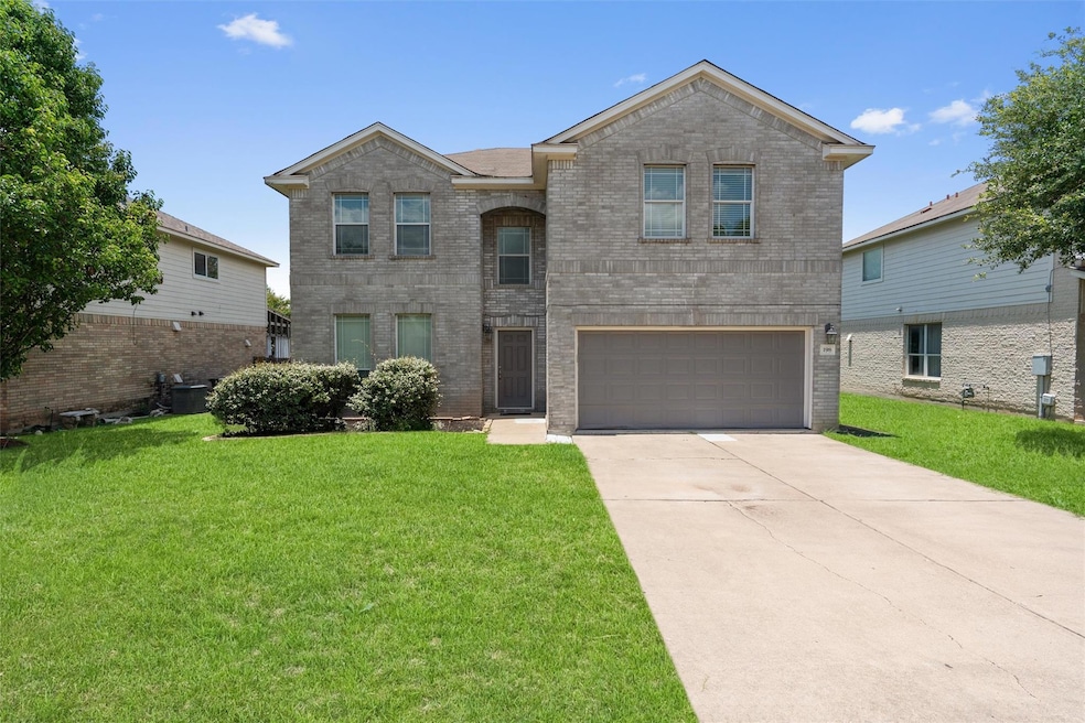 Traditional home with an attached garage, a front