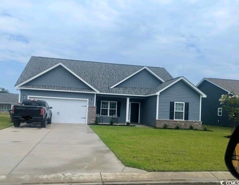 Craftsman-style home featuring a garage and a fron