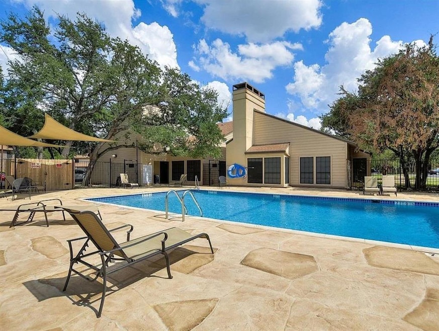 Community pool with a patio