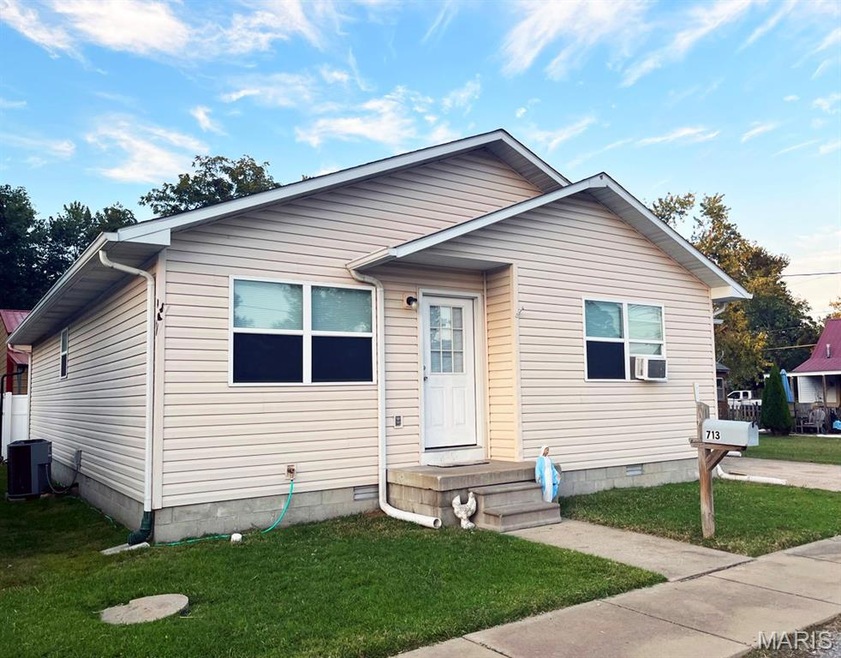 Bungalow-style home featuring a front lawn and crawl space