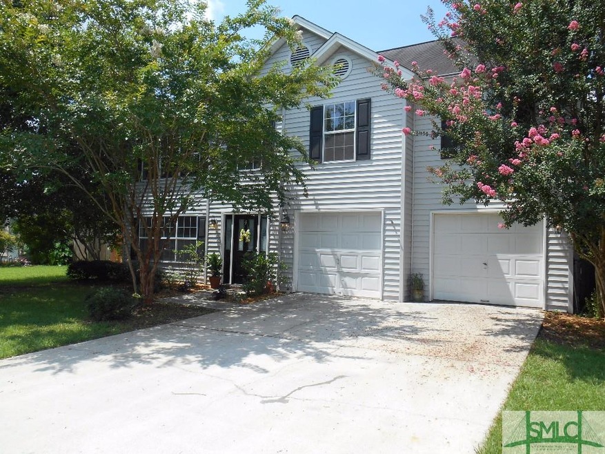 Large two story home with mature shade trees.