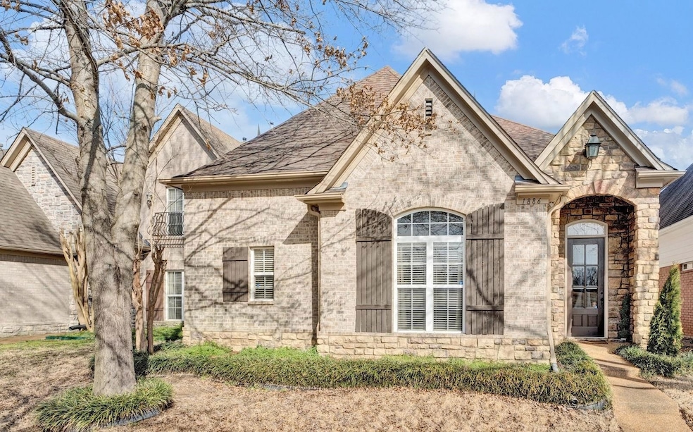 Traditional French style home with brick siding.