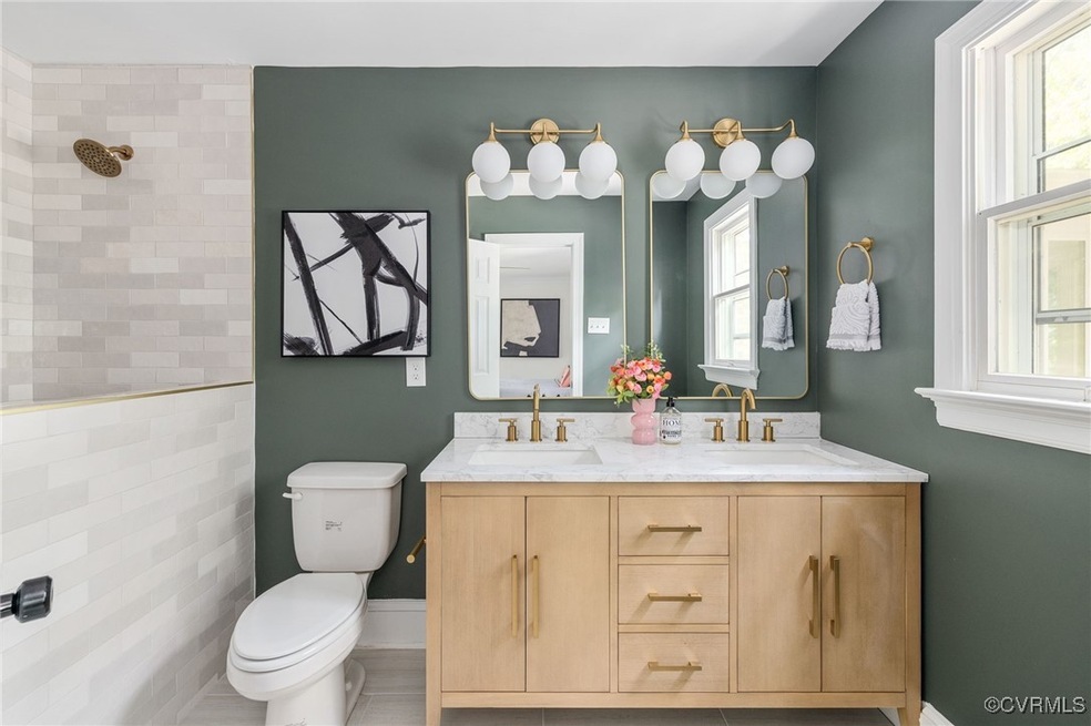 Primary bathroom with dual vanity, tile patterned