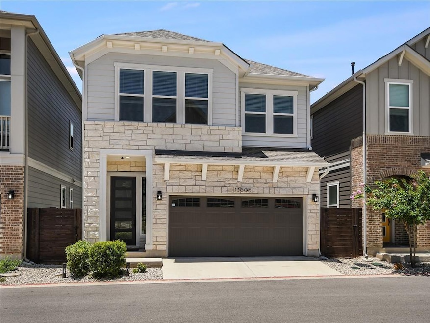 View of front of house featuring stone siding, an