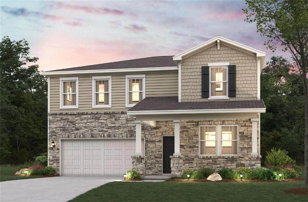 View of front of house with a garage and a lawn