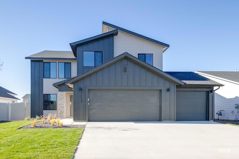 View of front facade with board and batten siding, roof with shingles, an attached garage, and concrete driveway