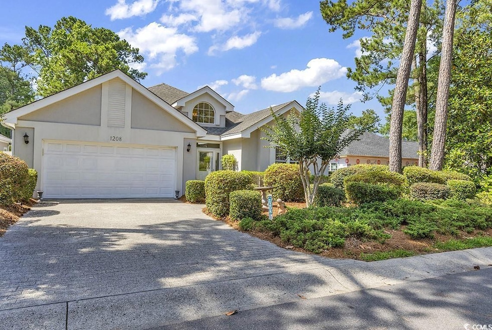 View of front facade with driveway, an attached garage, stucco siding, and roof with shingles