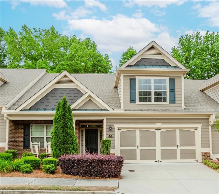 Craftsman house featuring roof with shingles, driveway, brick siding, and an attached garage