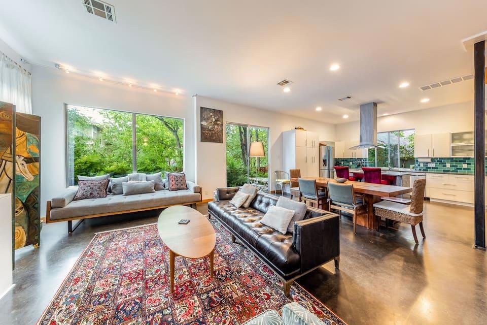 Living room with concrete floors, visible vents, 