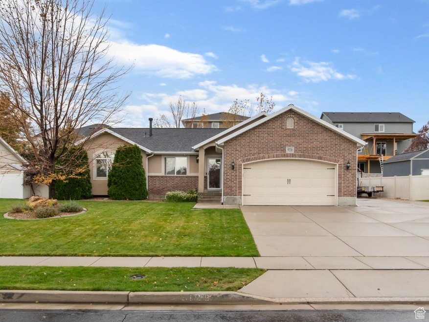 View of front of house featuring concrete driveway, an attached garage, and brick siding