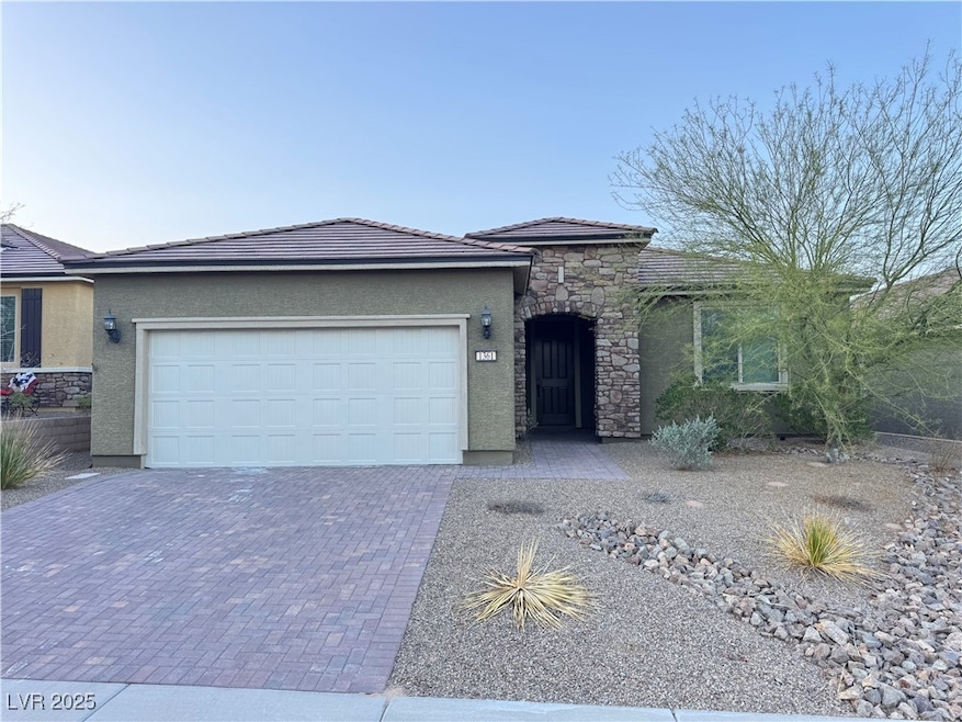 Ranch-style house with stone siding, stucco siding