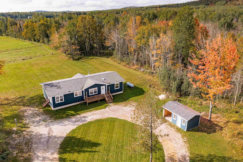 View of subject property with a heavily wooded area & also open area.