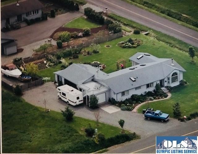 Home with three garages, RV parking, fenced storage, south facing deck, sun room, mtn & ocean views.