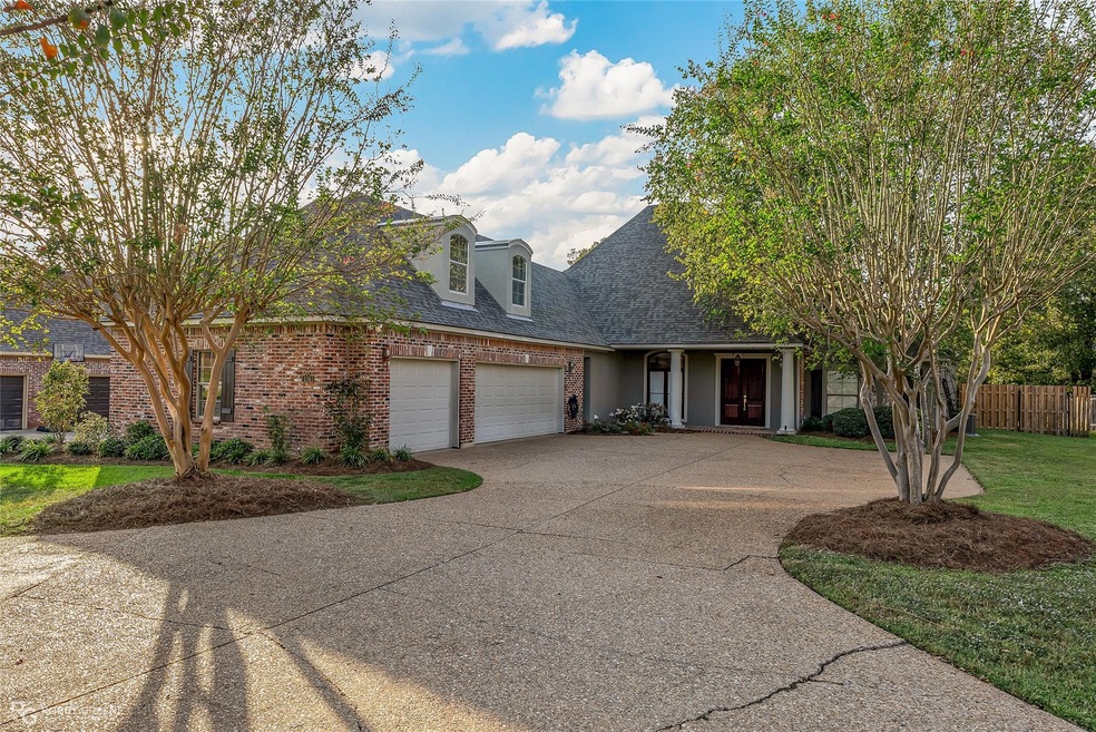 View of front of house with a front yard and a gar