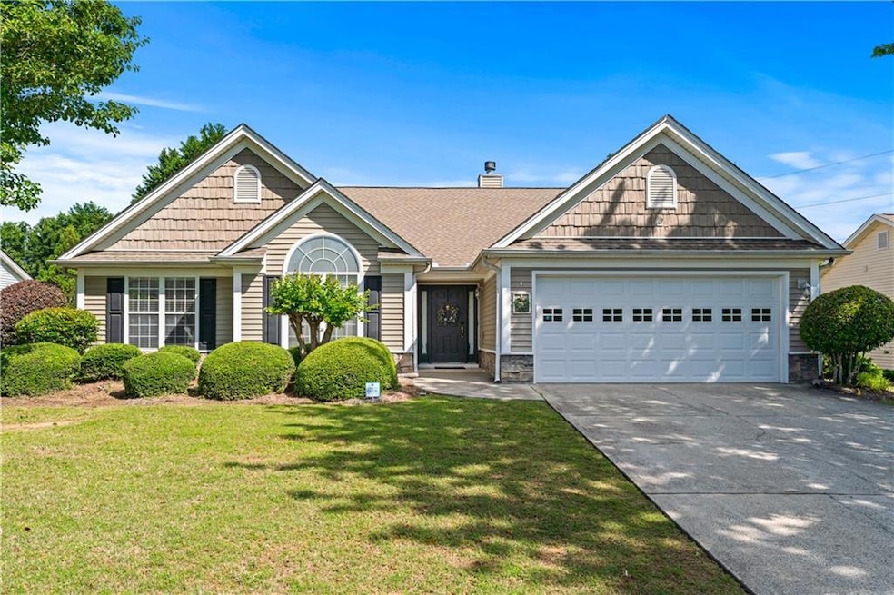 View of front of house with concrete driveway, a g