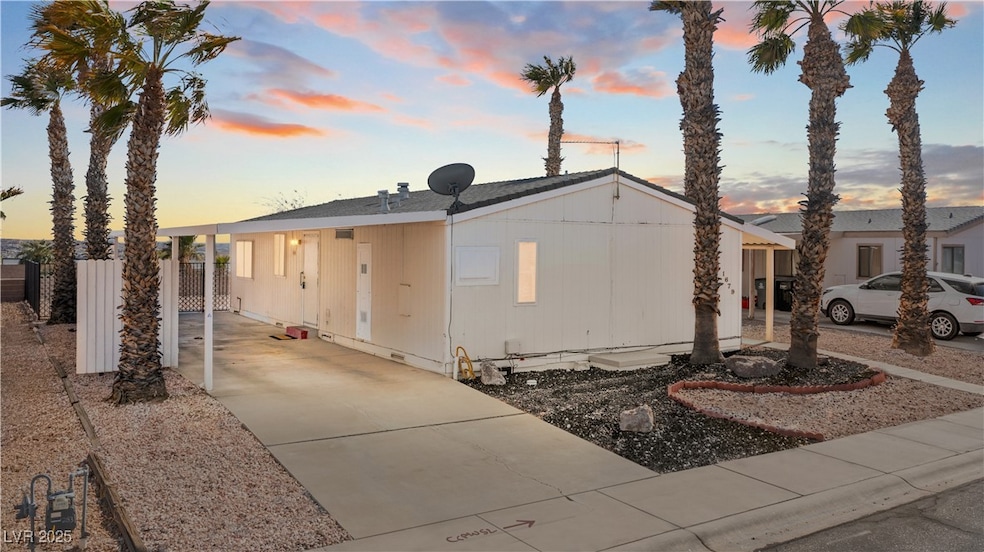 Manufactured home with driveway, attached carport,