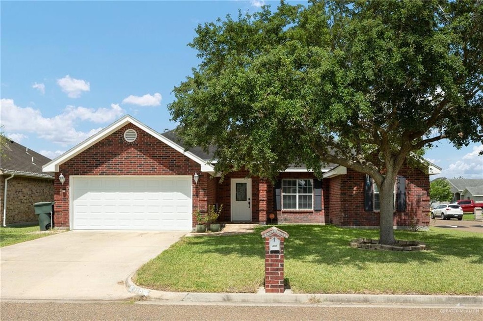 View of front facade featuring a garage and a front lawn