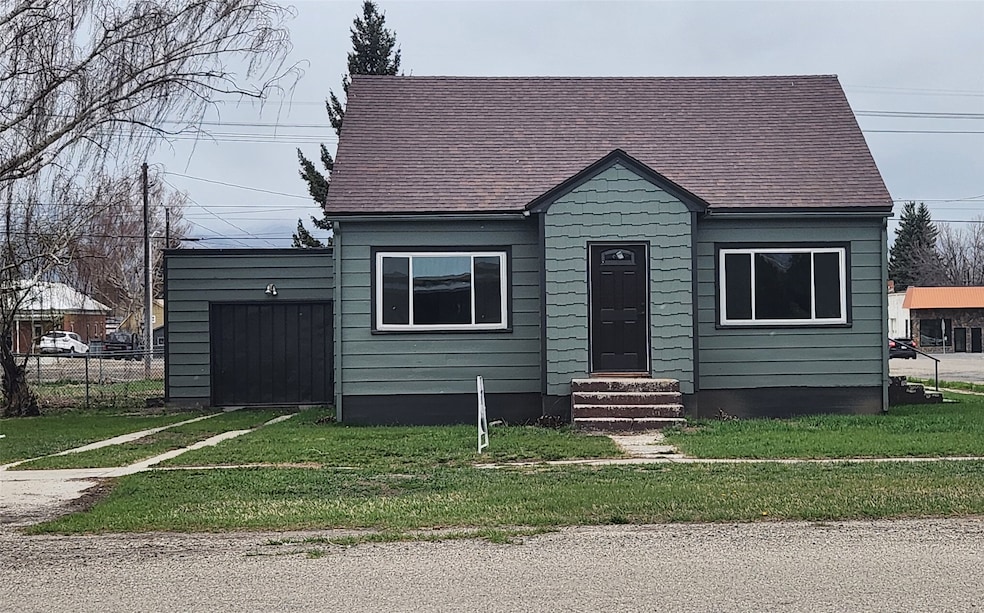 View of front of property featuring entry steps and a shingled roof