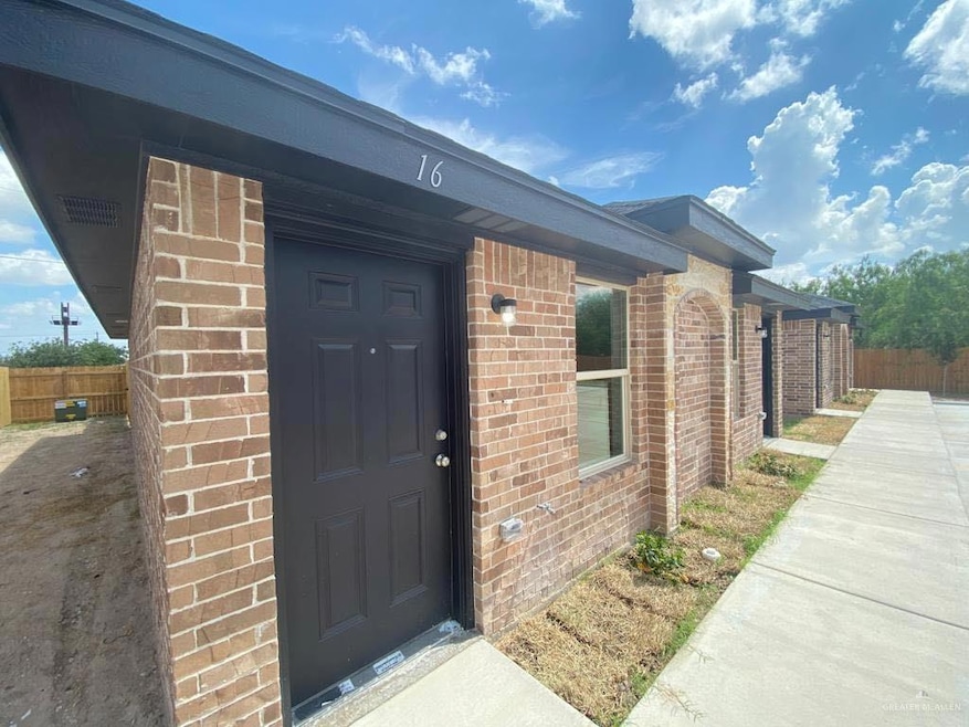 View of exterior entry featuring brick siding