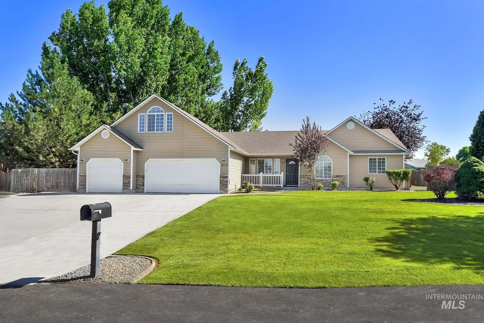 View of front facade featuring stone siding, driveway, and a garage