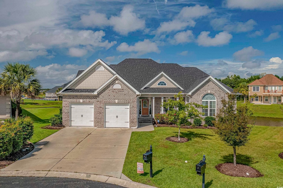 Craftsman-style house featuring brick siding, driveway, a front yard, and an attached garage