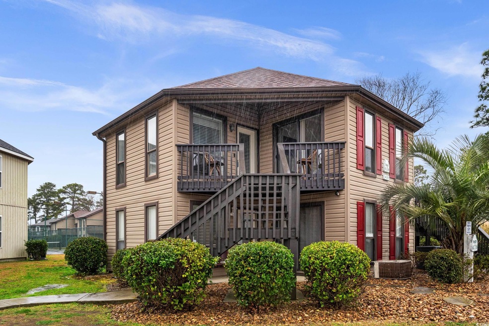 View of front facade featuring a shingled roof, st