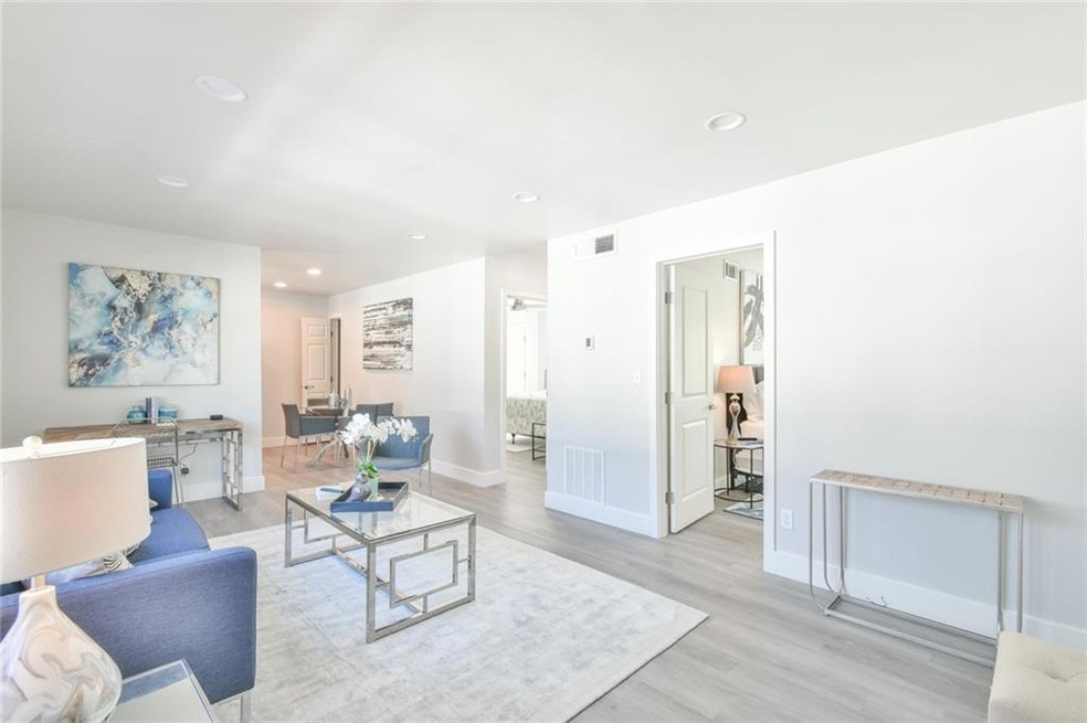 Living room with light hardwood / wood-style floor
