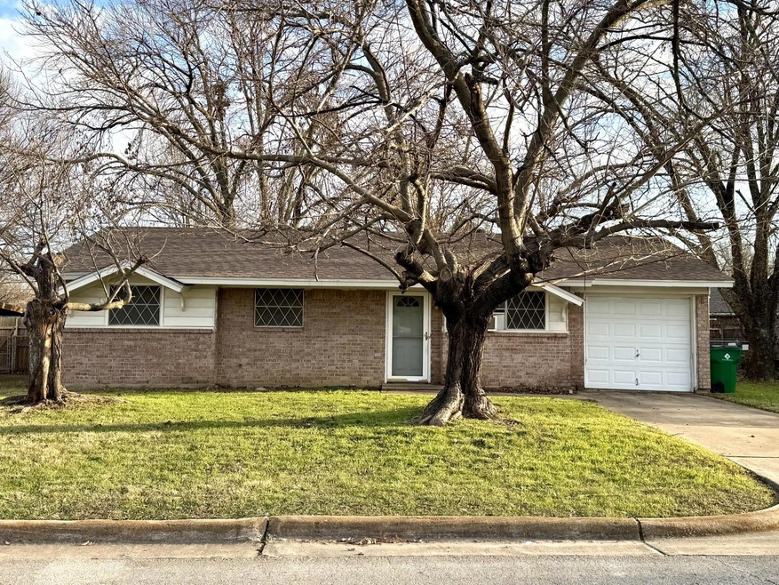 Ranch-style home with a garage and a front yard