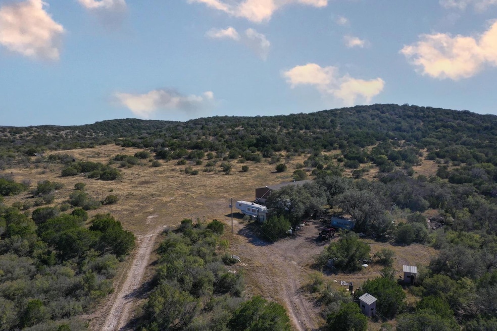 View of property location featuring a mountain backdrop and rural landscape