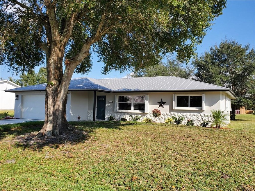 Beautiful new landscaping with a mature oak in the