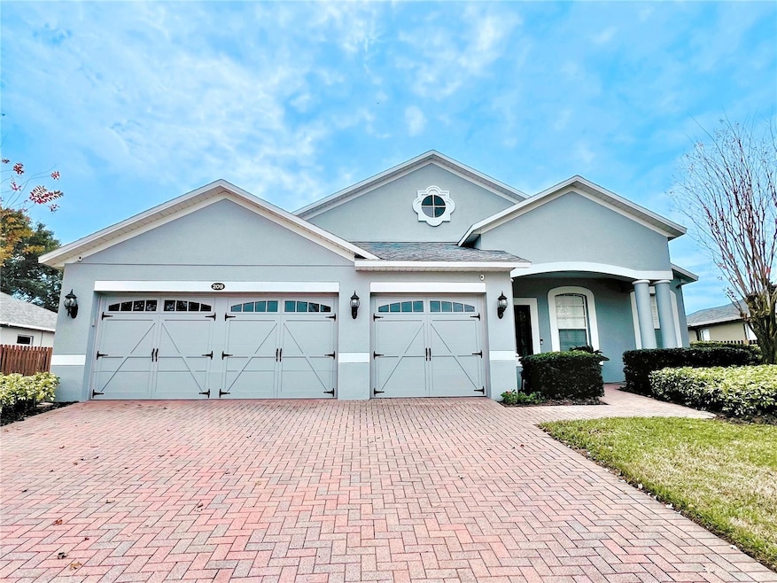 Front of Home with 3 Car Garage and Brick Pavered Driveway