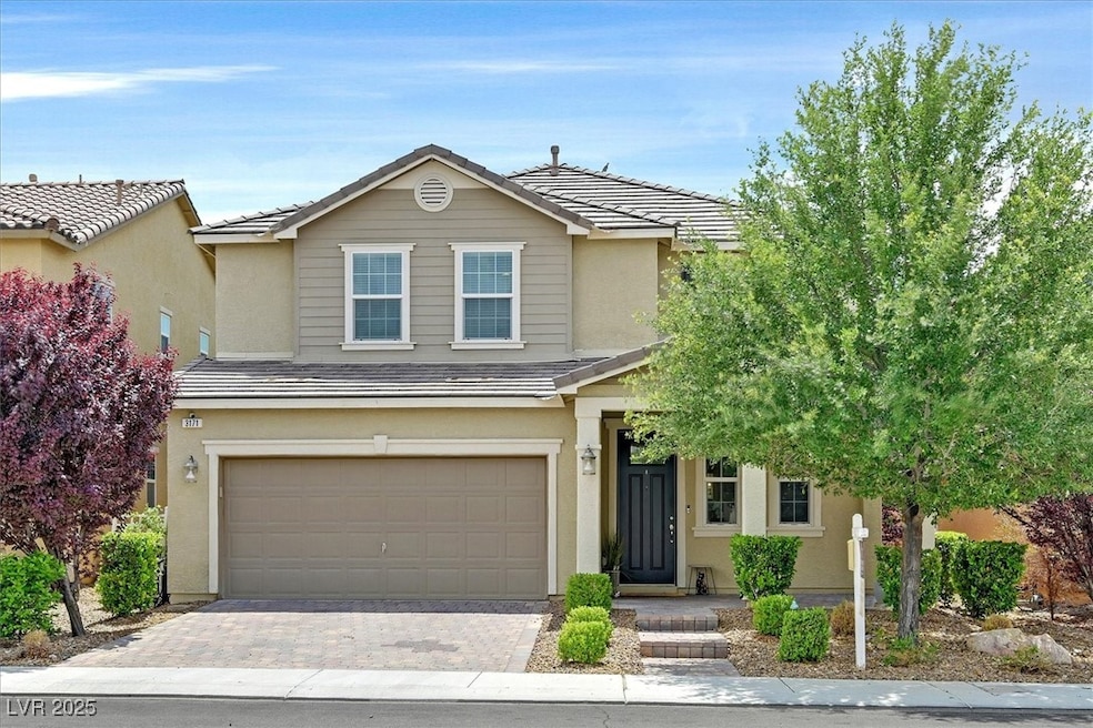 View of front facade with an attached garage, stuc