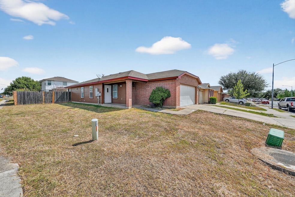Ranch-style home featuring brick siding, concrete driveway, and an attached garage